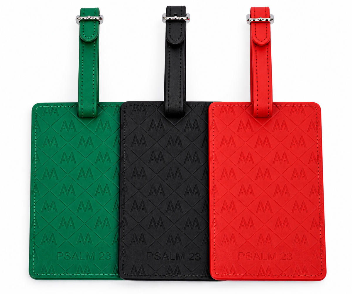 Three embossed leather luggage tags with diamond-patterned texture and silver metal buckles, shown side by side in green, black, and red on a white background.